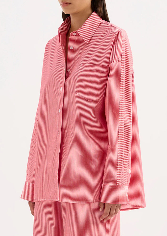 Person wearing a red striped shirt and pants on a white background