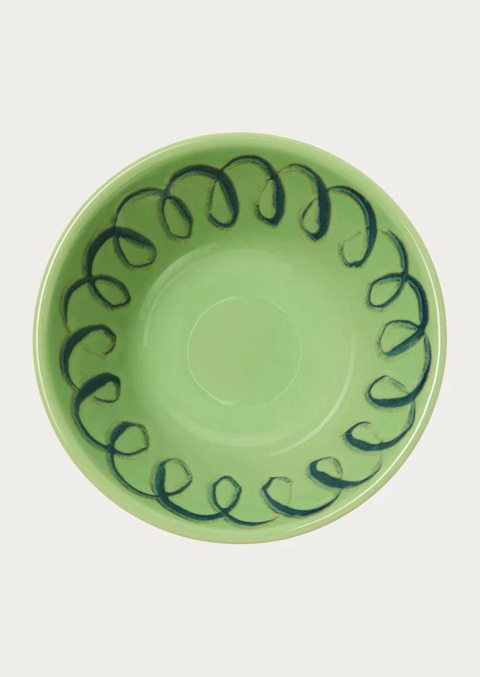 A green bowl with a squiggle design along the edge.