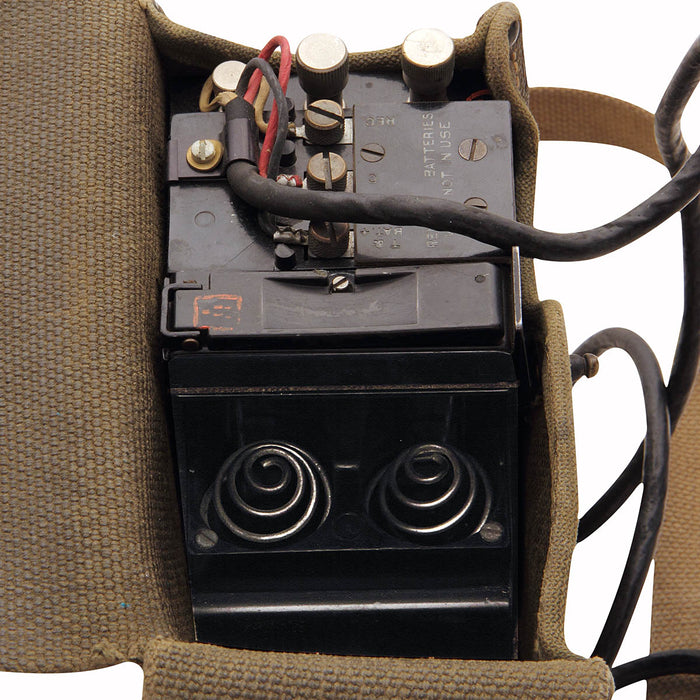 military surplus US Army Field Phone in canvas satchel uses two D-cell batteries and a connecting wire to function